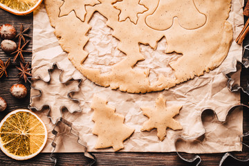 Christmas and New Year celebration traditions. Family home bakery, cooking traditional festive sweets. Gingerbread dough with christmas theme shapes and raw cookies