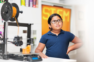 Young girl wearing glasses in a stem class who is representing minority students learning 3D...