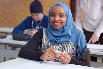 Beautiful female muslim african american architecture student looking and smiling into camera.