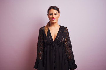 Young beautiful hispanic woman standing wearing black dress
