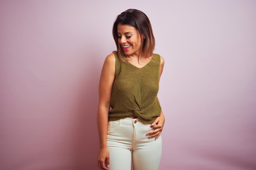 Young beautiful hispanic woman standing wearing green t-shirt