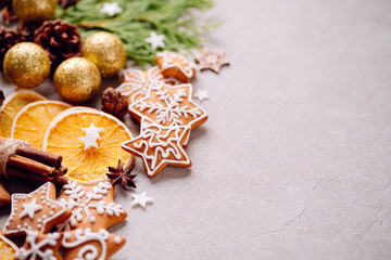 Christmas and New Year holidays preparations. Decorating presents, DIY, celebration concept. Christmas background with homemade gingerbread cookies, evergreen branches and decorations