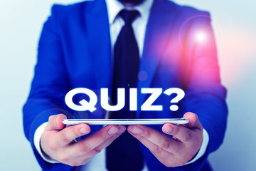 Handwriting text writing Quiz Question. Conceptual photo test of knowledge as competition between individuals or teams Businessman in blue suite with a tie holds lap top in hands