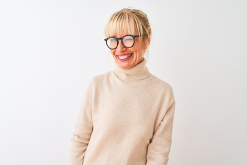 Middle age woman wearing turtleneck sweater and glasses over isolated white background winking...