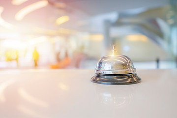 Hotel service bell on a table white glass. - obrazy, fototapety, plakaty