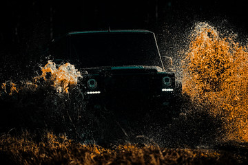 Jeep outdoors adventures. Tires in preparation for race. Tracks on a muddy field. Road adventure. Adventure travel. Rally racing. Mud and water splash in off-road racing. © Volodymyr