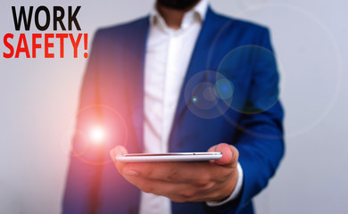Word writing text Work Safety. Business photo showcasing policies and procedures in place to ensure health of employees Business concept with man holding mobile phone with touch screen