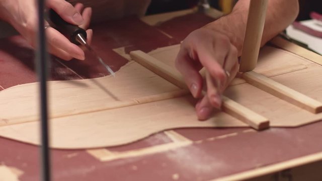 Professional guitar maker makes space for structure braces