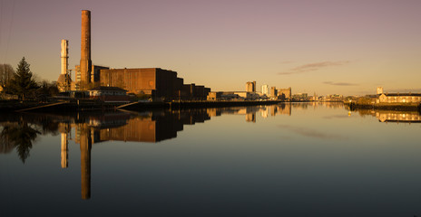 Naklejka premium Cork Ireland city center harbor panorama view morning sunrise cold weather calm river water reflection buildings colors 