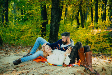 This is perfect cofe. Family picnic. Valentines day. couple in love relax in autumn forest. Camping and hiking. Happy woman and bearded man drink tee. Love date and romance. Spring mood