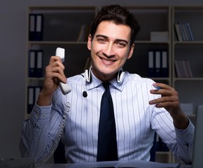 Call center operator talking to customer during night shift