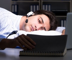 Tired and exhausted helpdesk operator during night shift