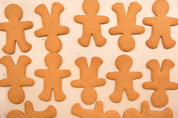 Gingerbread man cookies right out of the oven, freshly made at home, without decoration. Great for cooking with the kids as a family near the Christmas and winter holidays.