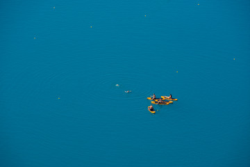 Fototapeta na wymiar Tourists swimming and kayaking on the Lake