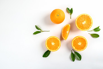 Orange  fruits with green leaves and slices isolated on white background.