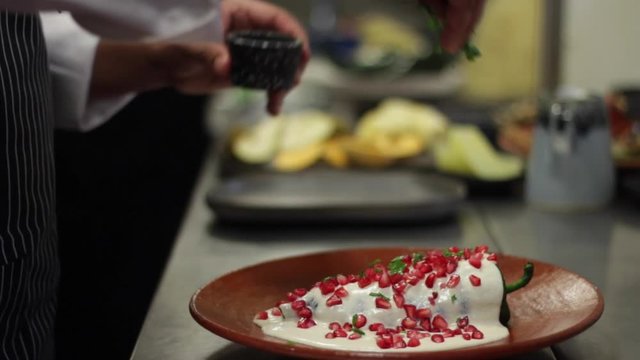 chef preparing chile en nogada, mexican traditional dish