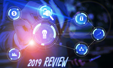 Writing note showing 2019 Review. Business concept for New trends and prospects in tourism or services for 2019 Male wear formal suit presenting presentation smart device