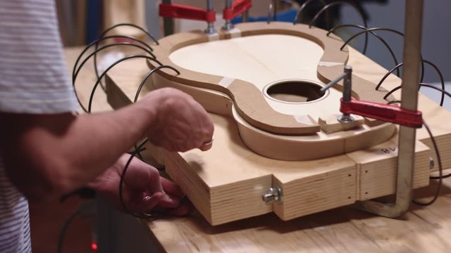 Guitar maker clamp together the acoustic guitar structure