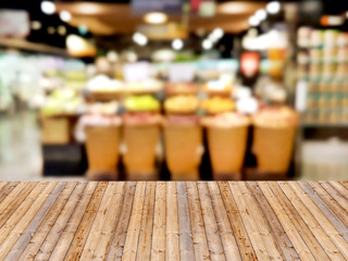 Wooden table with shopping mall blurred background