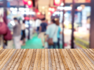Wooden table with shopping mall blurred background