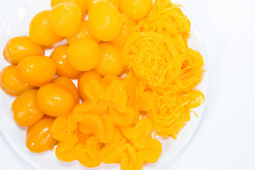 egg yoke fudge balls cooked in syrup on background