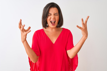 Young beautiful woman wearing red t-shirt standing over isolated white background celebrating mad...