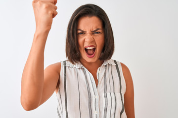 Young beautiful woman wearing casual striped shirt standing over isolated white background annoyed and frustrated shouting with anger, crazy and yelling with raised hand, anger concept