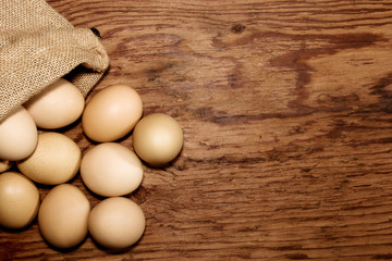 eggs in sackcloth bag on wooden table