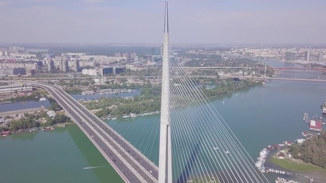 Fantastic long 4k aerial orbiting shot of Ada bridge in Belgrade and city center