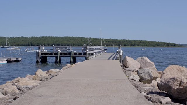 First person view walking onto a dock at the lake