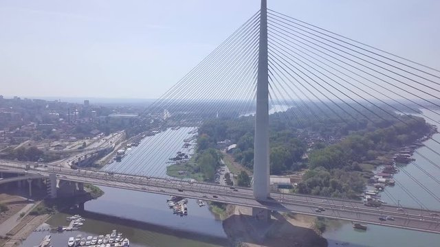 Panorama 4k shot revealing cars on Ada bridge in Belgrade, Serbia summer day