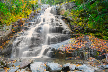 A waterfall in the fall full of fall or autumn colors in the forest