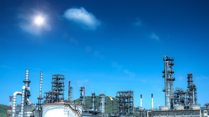 Oil and gas industrial refinery zone,Detail of equipment oil pipeline steel with valve from large oil storage tank at cloudy sky. -image