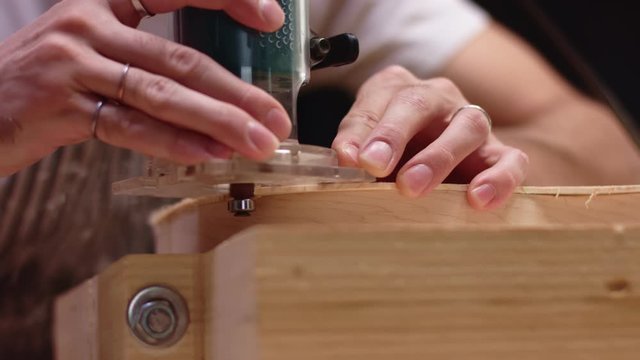 Luthier carving a guitar shape