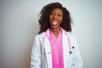 African american doctor woman wearing  pink stethoscope over isolated white background sticking tongue out happy with funny expression. Emotion concept.