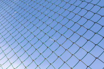 Metal mesh against the blue sky.