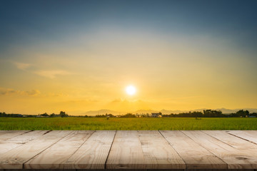 Rice field sunset and Empty wood table for product display and montage.