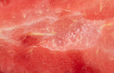 Texture of ripe watermelon with pits as a background.