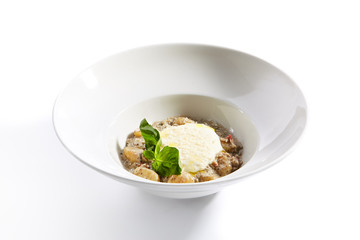 Gnocchi in mushroom sauce with cheese espuma closeup