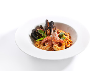 Delicious spaghetti with seafood and tomatoes close up