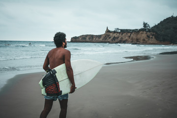 surfer boy in montañita beaches, ecuador