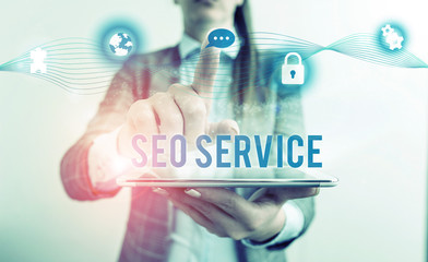 Conceptual hand writing showing Seo Service. Concept meaning techniques and procedures to increase the website visibility Female human wear formal work suit presenting smart device