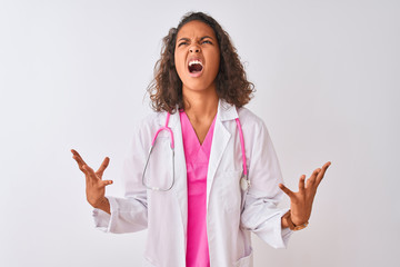 Young brazilian doctor woman wearing stethoscope standing over isolated white background crazy and...