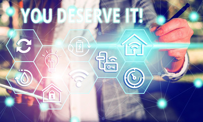 Word writing text You Deserve It. Business photo showcasing should have it because of their qualities or actions Female human wear formal work suit presenting presentation use smart device