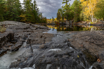 Fall colours (colors) view up river with reflection landscape