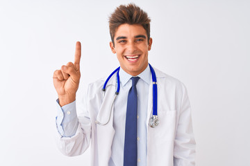Fototapeta na wymiar Young handsome doctor man wearing stethoscope over isolated white background showing and pointing up with finger number one while smiling confident and happy.