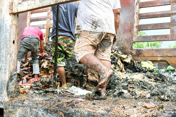 Poor people digging, searching and collecting rubbish for sale in Thailand.