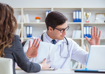 Young doctor in medical insurance fraud concept