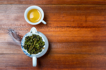 Chinese tea and cup on wooden background., top view
