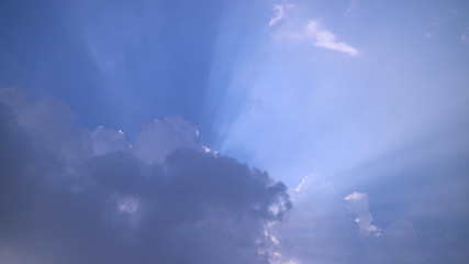 background of blue sky with grey cloud with ray of light